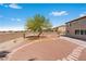 A spacious backyard features desert landscaping, stone pathways, and natural desert plants at 7756 River Mist Ct, Las Vegas, NV 89113