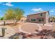 A backyard features desert landscaping, rock accents, and mature trees for privacy at 7756 River Mist Ct, Las Vegas, NV 89113