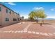 Large backyard with desert landscape, stone pathways, and views of the mountains and neighborhood homes at 7756 River Mist Ct, Las Vegas, NV 89113