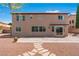 View of the back exterior, patio, and desert landscaping, creating a serene outdoor environment at 7756 River Mist Ct, Las Vegas, NV 89113