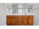 Bright bathroom featuring a double sink vanity with wood cabinets and a large mirror at 7756 River Mist Ct, Las Vegas, NV 89113