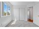 Bedroom featuring a large window, carpeted floor and a closet with doors at 7756 River Mist Ct, Las Vegas, NV 89113