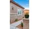 Home exterior displaying stone accents, desert landscaping, and a pathway leading to a corner lot at 7756 River Mist Ct, Las Vegas, NV 89113