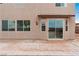 Home's exterior features a patio and a sliding glass door with a landscaped backyard at 7756 River Mist Ct, Las Vegas, NV 89113