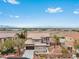 Inviting two-story home featuring a tile roof, desert landscaping, and an attached two-car garage at 7756 River Mist Ct, Las Vegas, NV 89113
