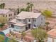 Beautiful two-story home with desert landscaping, and a view of the neighboring home and desert scenery at 7756 River Mist Ct, Las Vegas, NV 89113