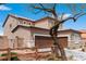 Two-story home showcases stucco siding, a two-car garage, desert landscaping, and a charming fence at 7756 River Mist Ct, Las Vegas, NV 89113