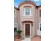 Home entrance showcasing a dark wood front door with light stone and stucco accents at 7756 River Mist Ct, Las Vegas, NV 89113
