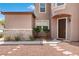 Home exterior featuring rock accents, desert landscaping, and a front entrance with dark wooden door at 7756 River Mist Ct, Las Vegas, NV 89113