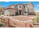 Charming two-story home featuring desert landscaping, a welcoming front entrance, and a quaint fence at 7756 River Mist Ct, Las Vegas, NV 89113