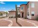 Attractive front yard with desert landscaping and a stone pathway leading to a stucco home with a tower feature at 7756 River Mist Ct, Las Vegas, NV 89113