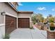Home featuring a three-car garage, stucco siding, and desert landscaping at 7756 River Mist Ct, Las Vegas, NV 89113