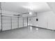 Clean, well-lit three-car garage with epoxy floors, offering ample parking and storage space at 7756 River Mist Ct, Las Vegas, NV 89113