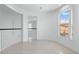 Bright hallway featuring tile floors and white railings at 7756 River Mist Ct, Las Vegas, NV 89113