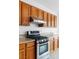 Updated kitchen features stainless steel oven and wooden cabinetry at 7756 River Mist Ct, Las Vegas, NV 89113