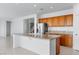 Open kitchen features island with stone countertop and stainless steel appliances at 7756 River Mist Ct, Las Vegas, NV 89113