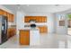 Open kitchen features wooden cabinets and island with granite countertops at 7756 River Mist Ct, Las Vegas, NV 89113