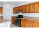 Updated kitchen features stainless steel oven and wooden cabinetry at 7756 River Mist Ct, Las Vegas, NV 89113