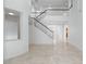 Spacious living area featuring high ceilings, marble floors, and a staircase at 7756 River Mist Ct, Las Vegas, NV 89113