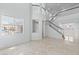 Bright living area with large windows, marble floors, and a view of the staircase at 7756 River Mist Ct, Las Vegas, NV 89113
