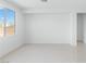 Bright living room with large window and tile floors at 7756 River Mist Ct, Las Vegas, NV 89113