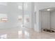 Bright living room with high ceilings, marble floors, and an abundance of natural light at 7756 River Mist Ct, Las Vegas, NV 89113