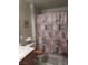 Modest bathroom featuring a toilet, shower with patterned curtain and neutral colors at 7894 W Patrick Ln, Las Vegas, NV 89113