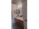 Bathroom showcasing a double sink vanity with wood cabinets and decorative mirrors at 7894 W Patrick Ln, Las Vegas, NV 89113