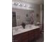 Bathroom featuring a double sink vanity with a white countertop and wood cabinets at 7894 W Patrick Ln, Las Vegas, NV 89113