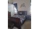 Cozy bedroom featuring a dark wood sleigh bed and decoratively adorned walls at 7894 W Patrick Ln, Las Vegas, NV 89113