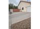 View of the driveway and front exterior featuring a garage and private gate at 7894 W Patrick Ln, Las Vegas, NV 89113