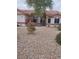 Inviting single-story home with a red-tiled roof and low maintenance gravel landscaping at 7894 W Patrick Ln, Las Vegas, NV 89113