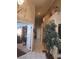 Hallway features tiled floors, art, and faux potted tree that enhances this interior at 7894 W Patrick Ln, Las Vegas, NV 89113