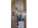 Hallway featuring neutral walls, decorative items, and white tile flooring at 7894 W Patrick Ln, Las Vegas, NV 89113