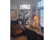 The home office features decor, a comfortable chair, and a well-lit workspace with large windows at 7894 W Patrick Ln, Las Vegas, NV 89113