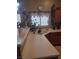 Kitchen counter with wood cabinets and white countertops at 7894 W Patrick Ln, Las Vegas, NV 89113