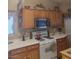 Cozy kitchen featuring a stainless steel microwave and wood cabinetry at 7894 W Patrick Ln, Las Vegas, NV 89113