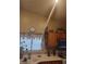 View of kitchen cabinets, a window, and white countertops at 7894 W Patrick Ln, Las Vegas, NV 89113