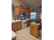 Well-lit kitchen with wood cabinets, white countertops, and an island at 7894 W Patrick Ln, Las Vegas, NV 89113