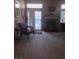 Living room featuring a fireplace, large sliding door, and a carpet floor at 7894 W Patrick Ln, Las Vegas, NV 89113