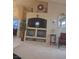 Living room with a built in TV console, decorations on the wall, and carpet at 7894 W Patrick Ln, Las Vegas, NV 89113