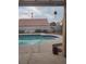 The backyard has a pool and a partially covered patio to provide shade at 7894 W Patrick Ln, Las Vegas, NV 89113
