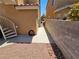 A narrow backyard with gravel and rocks, situated between two buildings at 8072 Cimarron Ridge Dr # 201, Las Vegas, NV 89128