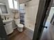 Bathroom featuring modern fixtures, a sink, a toilet, and a shower with a blue and white curtain at 8072 Cimarron Ridge Dr # 201, Las Vegas, NV 89128