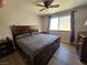 Bedroom with ceiling fan features a large bed and hardwood floors at 8072 Cimarron Ridge Dr # 201, Las Vegas, NV 89128