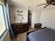 Bright bedroom features a ceiling fan, hardwood floors, and a large window at 8072 Cimarron Ridge Dr # 201, Las Vegas, NV 89128