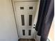 Front door of the home with a gray curtain to the side at 8072 Cimarron Ridge Dr # 201, Las Vegas, NV 89128