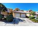 Inviting townhome with a tile roof, attached two-car garage, and manicured front yard in a well-kept community at 8072 Cimarron Ridge Dr # 201, Las Vegas, NV 89128