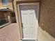 Exterior shot of a traditional white front door with dark hardware at 8072 Cimarron Ridge Dr # 201, Las Vegas, NV 89128