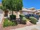 Charming townhome featuring a well-manicured lawn, desert landscaping, and an attached two-car garage at 8072 Cimarron Ridge Dr # 201, Las Vegas, NV 89128
